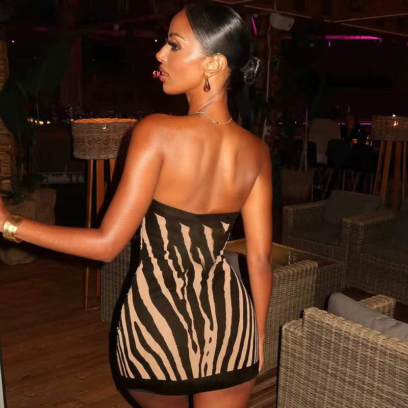 Back view of zebra-print strapless mini dress showing bodycon fit and sculpted waist