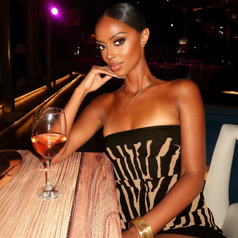 Zebra-print mini dress styled for upscale night-out look inside a lounge with low lighting