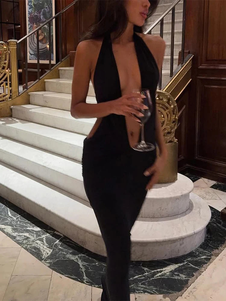 Front view of black halter evening dress with low neckline and sleek maxi fit.